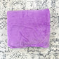 Plush lilac blanket, folded.